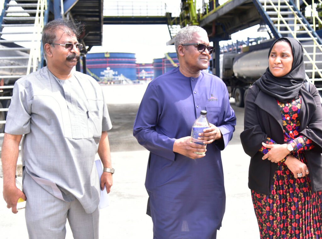 Vice President, Oil & Gas, Dangote Industries Limited, Devakumar Edwin; President/CE, Dangote Industries Limited, Aliko Dangote, holding a sample of newly refined PMS; Group Executive Director, Commercial Operations, Dangote Industries Limited, Fatima Aliko Dangote during the unveiling of the first output of the Premium Motor Spirit (PMS) product (Petrol), from the Dangote Petroleum Refinery, Lekki Lagos on Tuesday, September 3, 2024