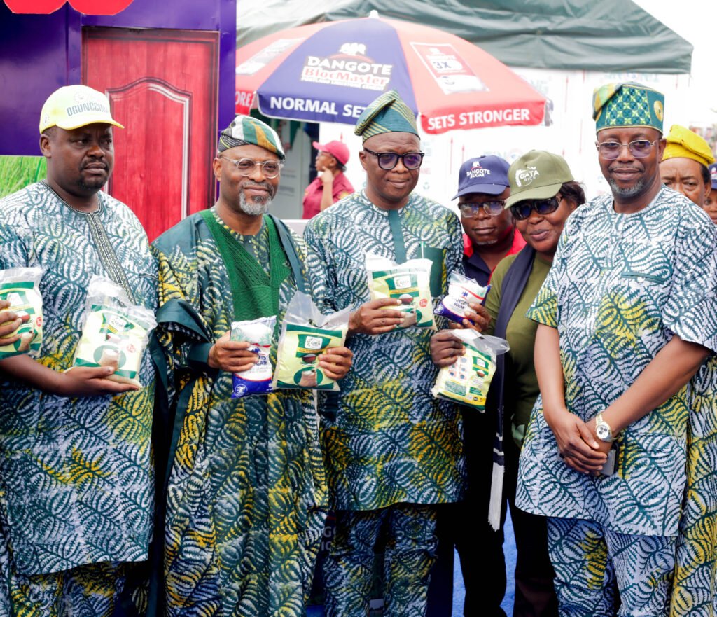 OGUNCCIMA President, Lion Niyi Oshiyemi; Representative of Ogun State governor and Commissioner for Industry, Trade and Investment, Mr. Emmanuel Adebola Sofela; Commissioner for Education, Prof. Abayomi Arigbabu and the Permanent Secretary, Ogun State Ministry of Industry, Trade and Investment, Engr. Kehinde Akintomide holding packs of Dangote Sugar, Rice and Salt when they visited the Dangote Group stand at the ongoing Trade Fair in Abeokuta
